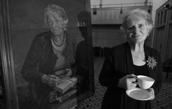 Edna Lonlgey standing next to a portrait of herself