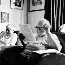 Philip Hobsbaum reading student work with his wife Rosemary in the background